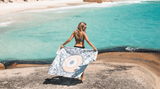 Woman in sand free towel standing on a beautiful beach Nakie - Australia