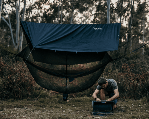 Man in Nakie Hammock camping ecosystem in the bush