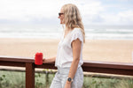 Campfire Red coffee cup lid shown on beverage container held by woman at beach preview #2