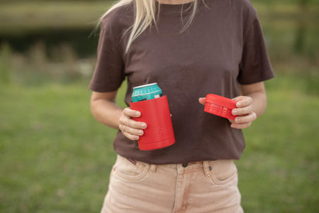 Red cylindrical insulated coffee cup with turquoise lid, shown open in hands