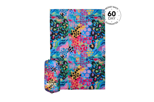 Colorful patchwork puffy blanket with leopard print, polka dots, and abstract patterns in blue, pink