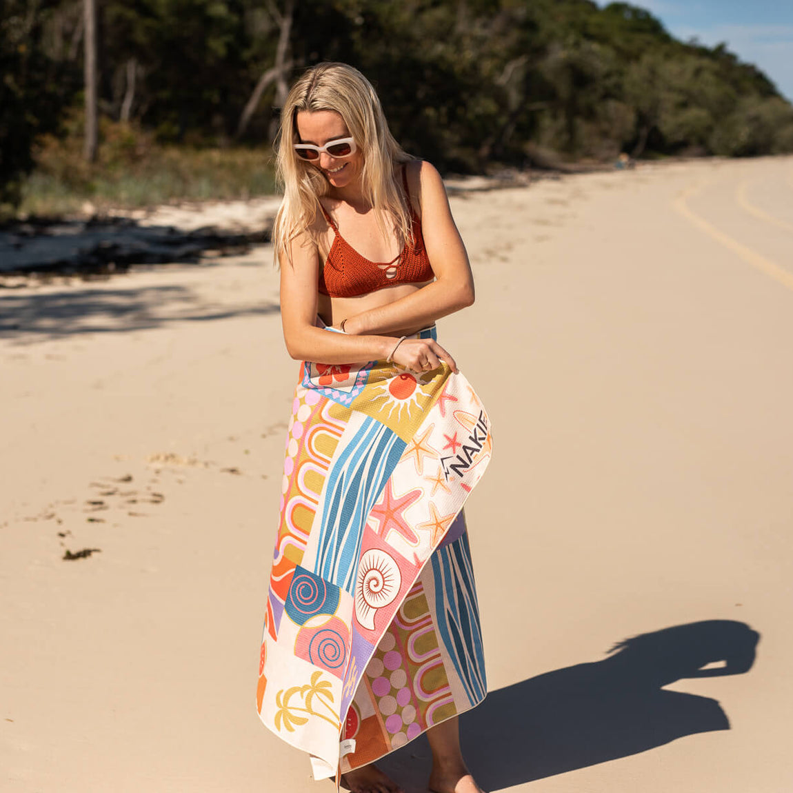 Retro Shores recycled sand-free beach towel in multicolor geometric print, displayed on beach
